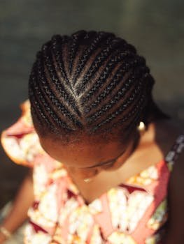 Detailed top view of intricate braided hairstyle on woman's head, showcasing traditional beauty.